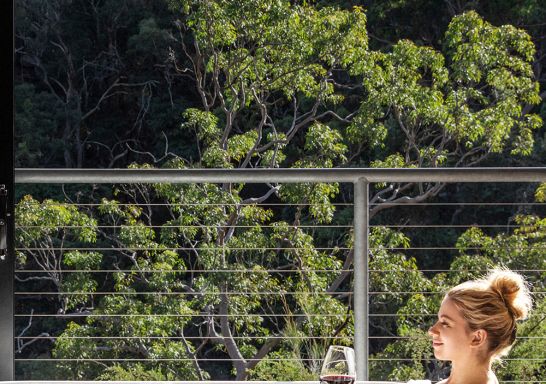 Woman relaxing in the bath with views at Spicers Sangoma Retreat, Bowen Mountain