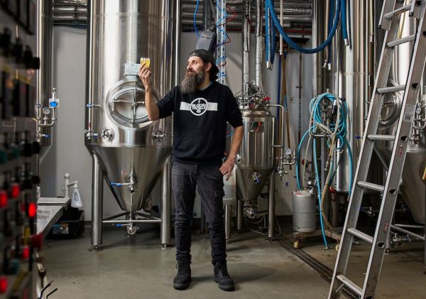 Man holding a beer in the brewery at Block n Tackle, Kincumber